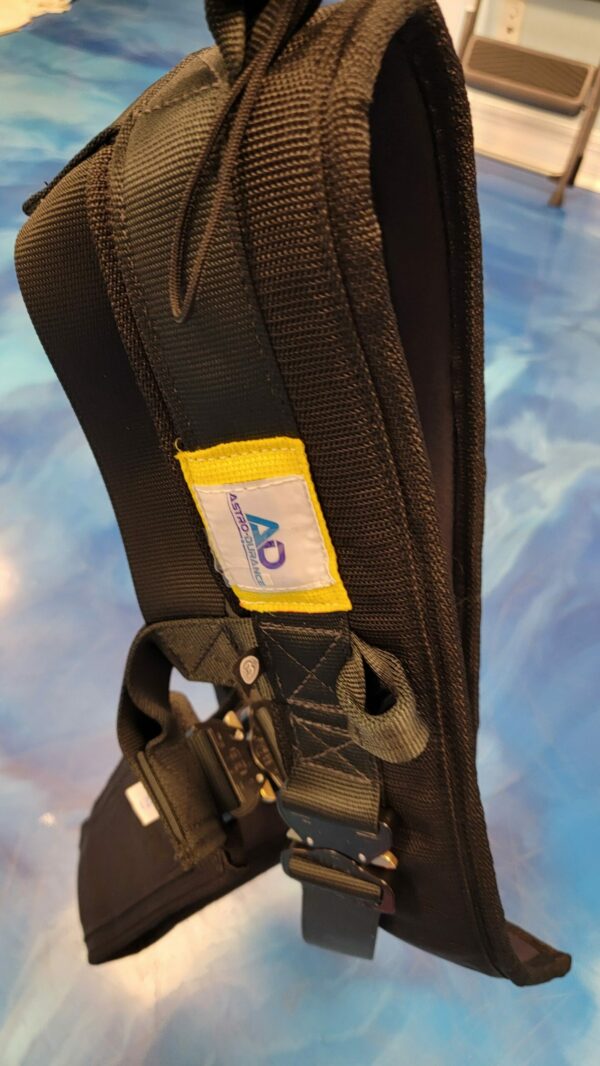 Durable harness strap close-up with adjustable buckles and prominent brand label on display.