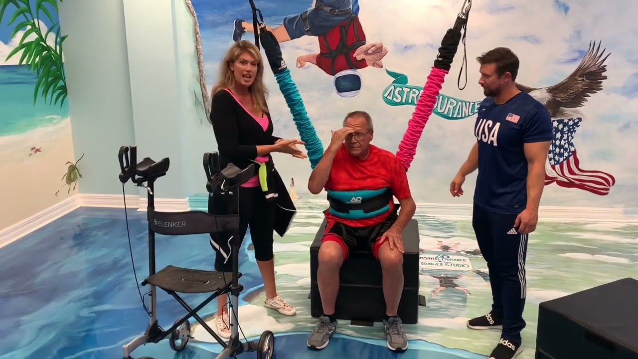 Emotional support in bungee therapy session at a rehabilitation center with engaged therapists.